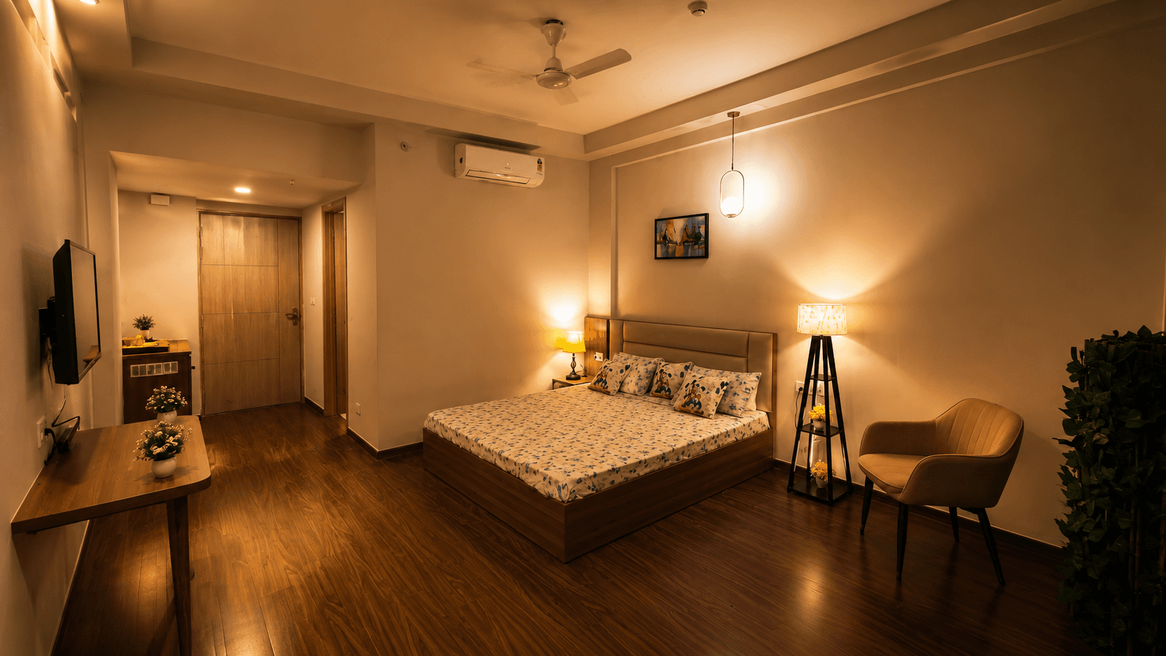 Bedroom with warm lamps and a wooden floor