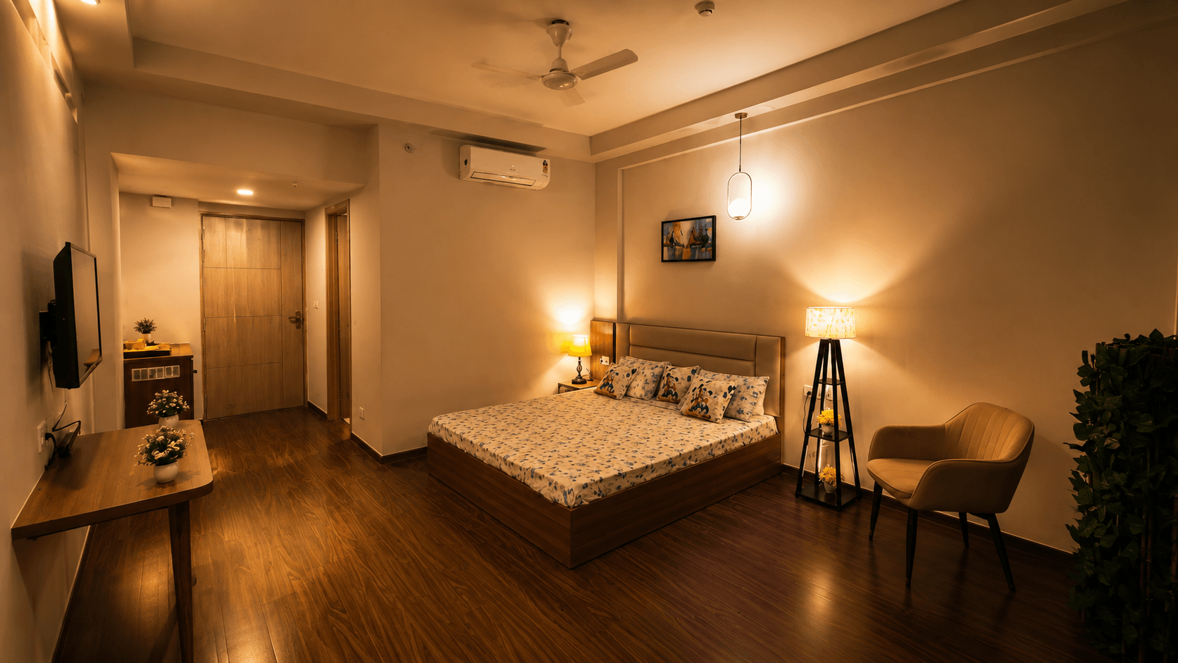 The bedroom at The Urban Hideout — warm lamps, wooden floor, queen bed