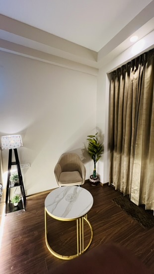 Sitting area with marble table and velvet chair